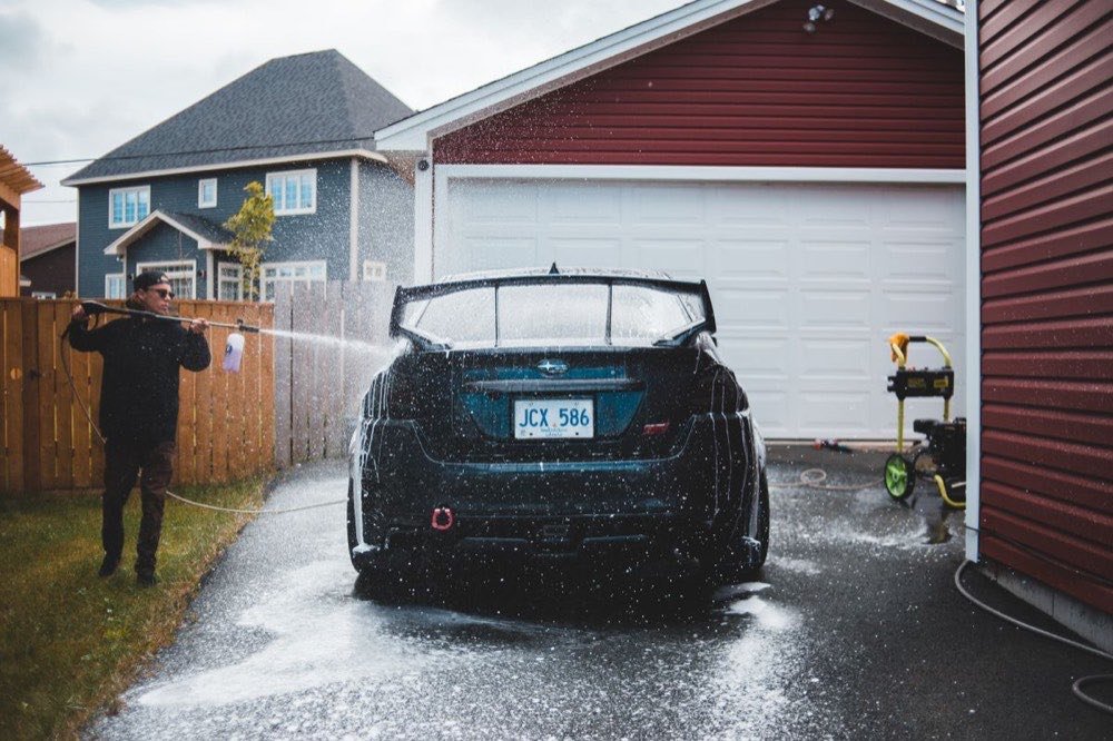 Pressure washing a concrete driveway